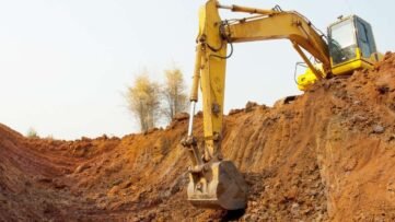Máquinas de escavação em ação em um canteiro de obras, preparando o terreno para construção.